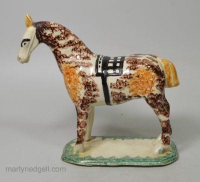 Pearlware pottery cow creamer decorated with colours and sponging under the glaze, circa 1820