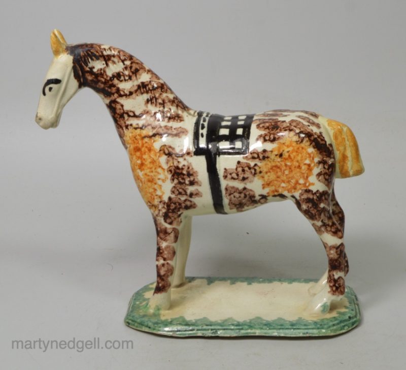 Pearlware pottery cow creamer decorated with colours and sponging under the glaze, circa 1820