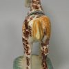 Pearlware pottery cow creamer decorated with colours and sponging under the glaze, circa 1820