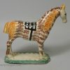 Pearlware pottery cow creamer decorated with colours and sponging under the glaze, circa 1820