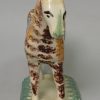 Pearlware pottery cow creamer decorated with colours and sponging under the glaze, circa 1820