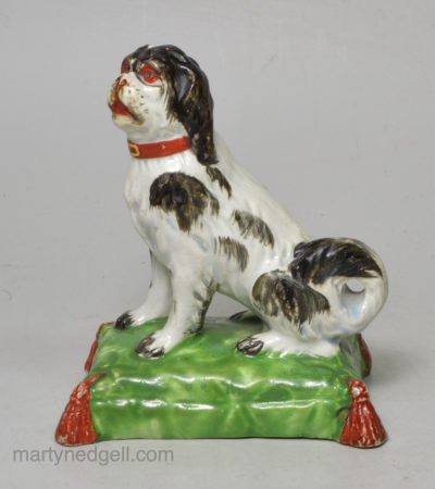 Staffordshire pearlware pottery dog decorated with overglaze enamels, circa 1820