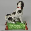 Staffordshire pearlware pottery dog decorated with overglaze enamels, circa 1820