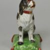 Staffordshire pearlware pottery dog decorated with overglaze enamels, circa 1820
