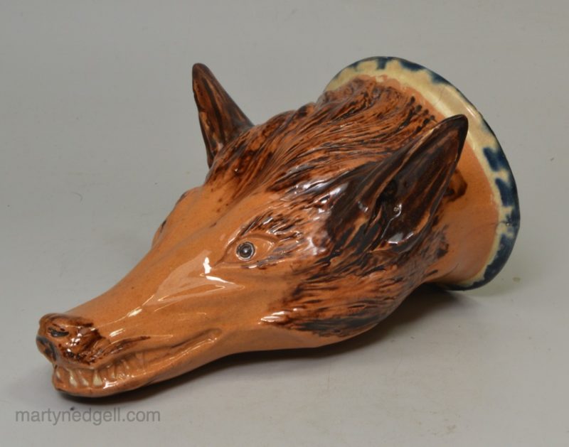 Buff pottery fox head stirrup cup, circa 1820