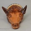Buff pottery fox head stirrup cup, circa 1820