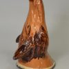 Buff pottery fox head stirrup cup, circa 1820