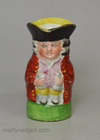 Miniature pearlware pottery Toby jug decorated with enamels over the glaze, circa 1820