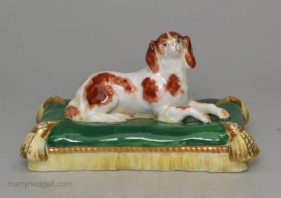 Minton porcelain spaniel lying on a cushion, circa 1835