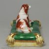 Minton porcelain spaniel lying on a cushion, circa 1835