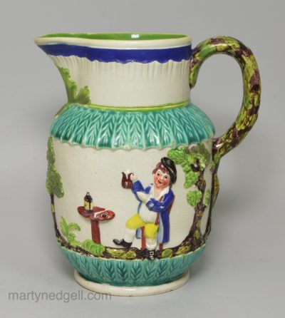 Pearlware pottery jug moulded with the Vicar, Sexton and Clerk decorated with colours over the glaze, circa 1810