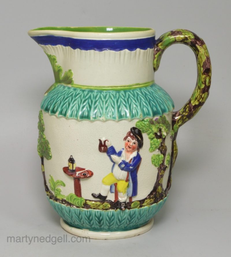 Pearlware pottery jug moulded with the Vicar, Sexton and Clerk decorated with colours over the glaze, circa 1810