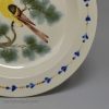 Creamware pottery plate decorated with a canary and sponged trees under the glaze, circa 1820