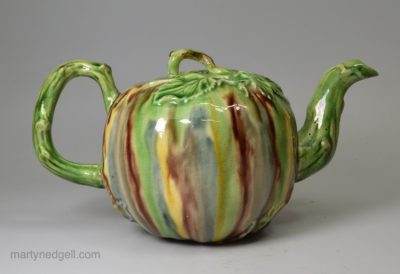 Creamware pottery teapot decorated with Whieldon type colours under the glaze, circa 1770