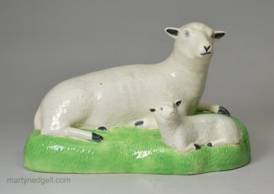 Creamware pottery model of a ewe and lamb decorated under the glaze, circa 1800
