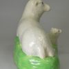 Creamware pottery model of a ewe and lamb decorated under the glaze, circa 1800