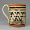 Mochaware mug decorated with inlaid brown slip on a creamware pottery body, circa 1820