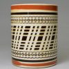 Mochaware mug decorated with inlaid brown slip on a creamware pottery body, circa 1820