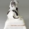 Staffordshire porcelain spaniel on a cushion, circa 1840