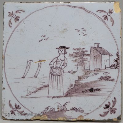 Bristol delft tile of woman holding a baby, circa 1750