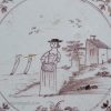 Bristol delft tile of woman holding a baby, circa 1750