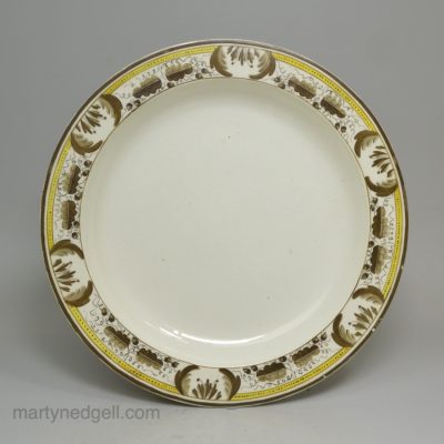 Creamware pottery plate decorated with over glaze enamels, circa 1800