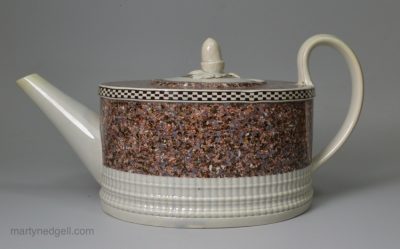Pearlware pottery teapot decorated with a layer of agate ware, circa 1800