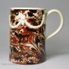 Mochaware pearlware pottery mug decorated with combed slip, circa 1790