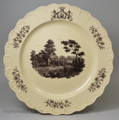 Wedgwood creamware plate printed with a watermill scene below an armorial, circa 1775