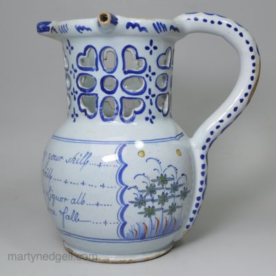 Liverpool delft puzzle jug, circa 1750 decorated with 2 polychrome panels