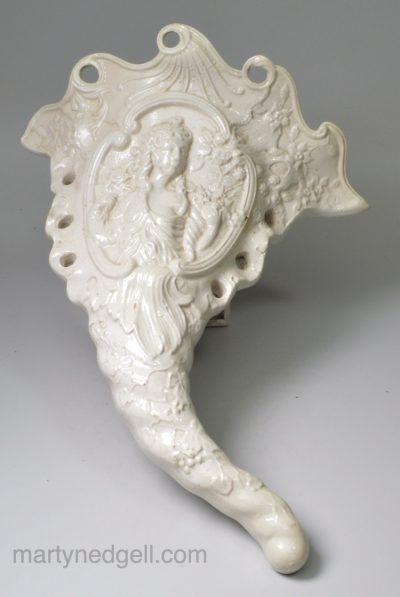 Staffordshire saltglaze stoneware wall pocket moulded with Flora, circa 1760
