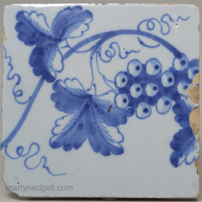 Liverpool delft tile painted in blue with grapes and vine, circa 1750