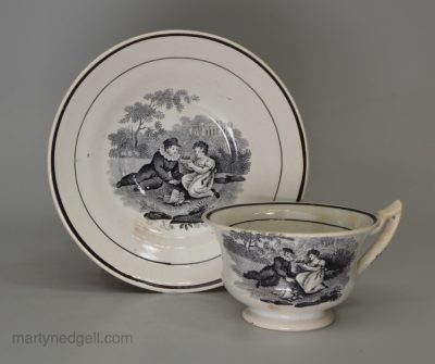 Pearlware pottery toy cup and saucer decorated with a black print under the glaze, circa 1820