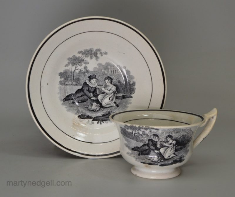 Pearlware pottery toy cup and saucer decorated with a black print under the glaze, circa 1820