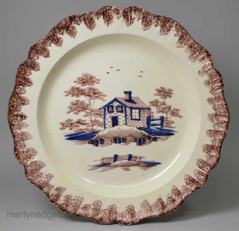 Creamware pottery plate moulded with a shell edge decorated with colours under the glaze, circa 1790