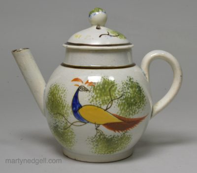 Prattware pottery child's toy teapot decorated with a peahen under the glaze, circa 1810