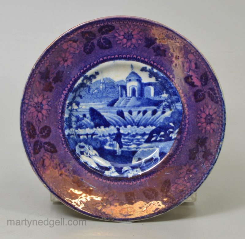 Pearlware pottery cup plate decorated with a blue transfer print and a pink lustre border, circa 1820
