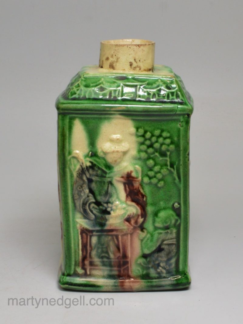 Creamware pottery tea canister moulded with Chinese subjects and decorated with colour under the glaze, circa 1770