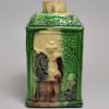 Creamware pottery tea canister moulded with Chinese subjects and decorated with colour under the glaze, circa 1770