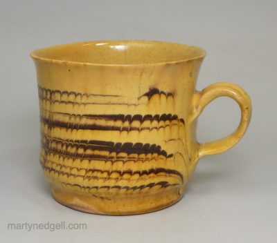 Staffordshire slipware mug with combed decoration, circa 1700