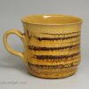 Staffordshire slipware mug with combed decoration, circa 1700