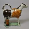 Pearlware pottery cow creamer decorated with colours under the glaze, circa 1820