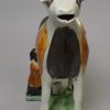 Pearlware pottery cow creamer decorated with colours under the glaze, circa 1820