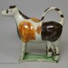 Pearlware pottery cow creamer decorated with colours under the glaze, circa 1820