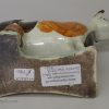 Pearlware pottery cow creamer decorated with colours under the glaze, circa 1820