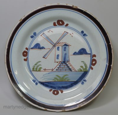 London delft pancake plate painted with a windmill, circa 1740