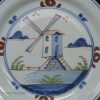 London delft pancake plate painted with a windmill, circa 1740