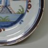 London delft pancake plate painted with a windmill, circa 1740