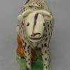 Creamware pottery cow creamer decorated with colours under the glaze, circa 1810