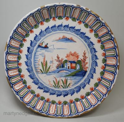 London delft charger decorated in in red, blue and green, circa 1700 probably Vauxhall